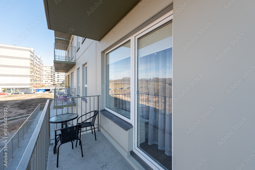 Fototapeta premium Cozy Balcony With Outdoor Seating in a Modern Residential Area