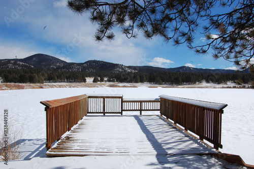 wooden bridge in the mountains on a frozen lake