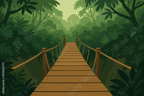 Wooden bridge on a path through a dense jungle surrounded by green trees and plants in the early morning light