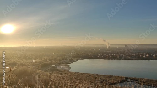Wallpaper Mural Breathtaking cityscape sunrise over lake with smokestacks and misty morning sky Torontodigital.ca