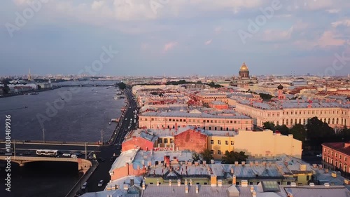 Neva River in the city of St. Petersburg in the summer season. Warm sunny weather. Tourist destinations in Russia. Ships and boats on the river. Bridge with cars. City center on Neva River from above.