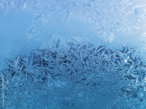 Beautiful ice patterns on winter window glass, close-up
