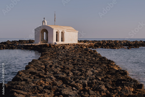 Picturesque seclusion: the whitewashed chapel on a narrow rock jetty extending into the Aegean