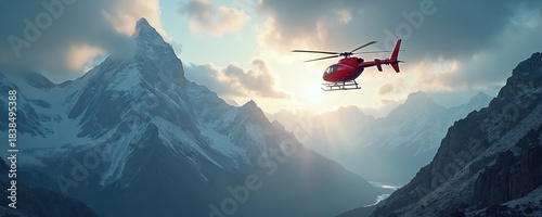 Red helicopter flies over snowy mountain range at sunrise. Sun rays break through clouds illuminating majestic landscape. Aerial transport above remote wilderness valley.