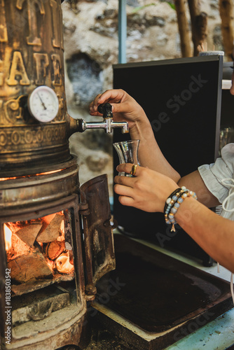 Slika na platnu Woman's hand pouring tea from samovar
