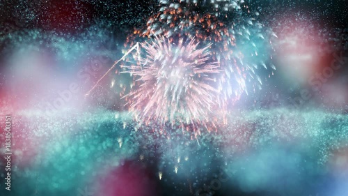 Blurred colorful bokeh with fireworks looping animation background.
