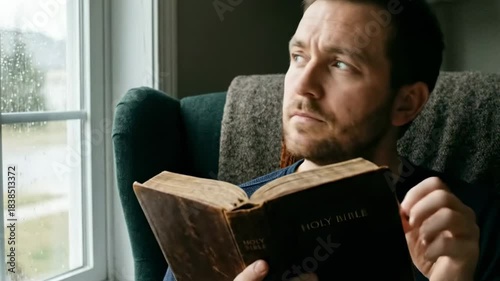 preacher home - Christian man reading Holy Bible sitting by window in morning light peaceful faith concept.