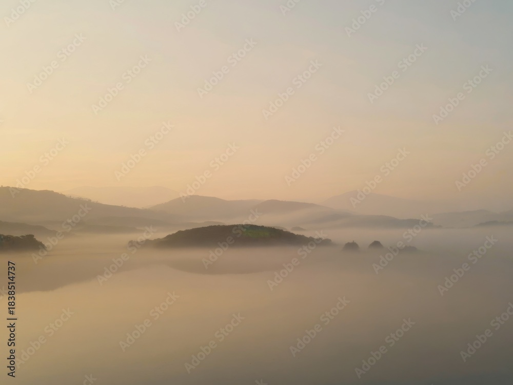 Fototapeta premium Misty Sunrise Over Calm Hills Landscape
