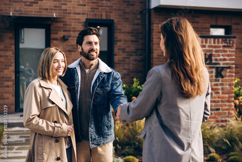 Принти на полотні Smiling successful woman and man shaking hands with realtor buying property on t