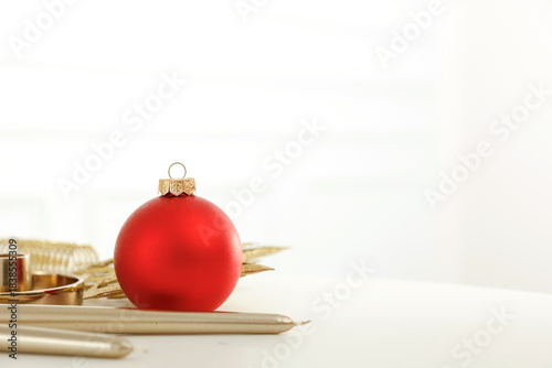 Minimalist holiday composition with elegant Christmas baubles on bright, clean background. Simple, modern festive winter decor, holiday and New Year themes. Copy space for text or product placement.
