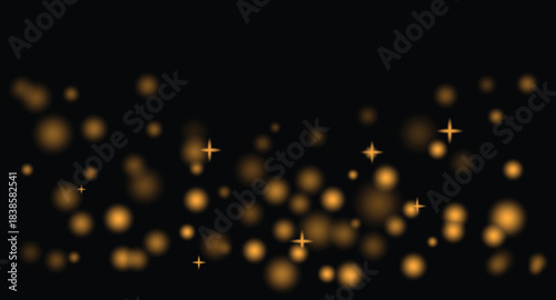 Abstract golden glitter particles glowing on dark background festive atmosphere with shining bokeh effect