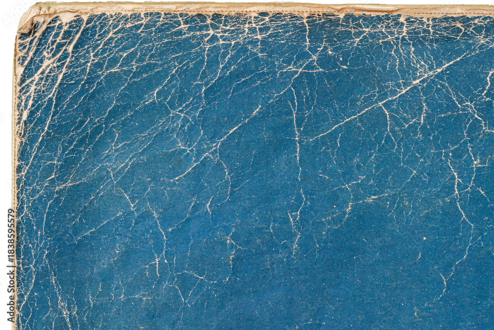 Naklejka premium Blue cracked book cover. Close-up of vintage textured blue book cover with dramatic cracked surface. Natural background for retro design, nostalgia, creative grunge effect. Copy space