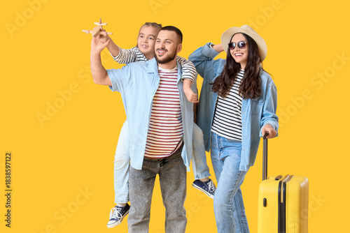 Family of travelers with su...
