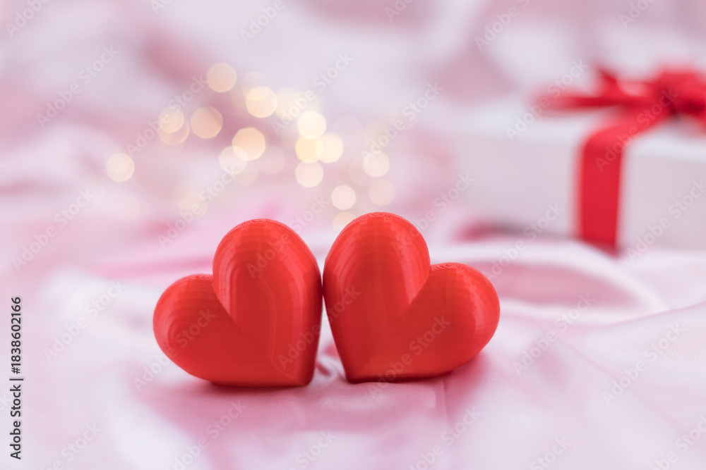 Fototapeta premium Valentines decoration with red hearts and ribbon present.