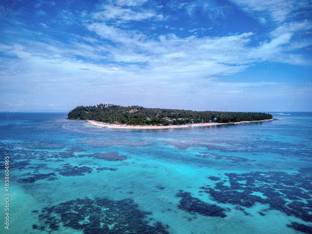Fototapeta premium Tropical island surrounded by shallow turquoise reef