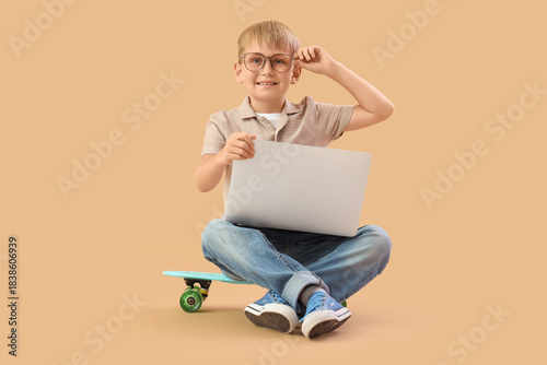 Little boy with laptop stud...