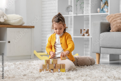 Cute little girl playing wi...