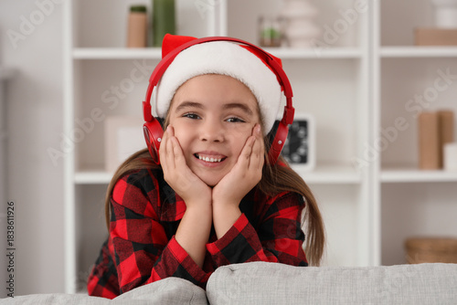 Cute little girl in headpho...