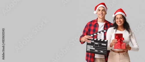 Young couple in Santa hats,...