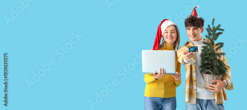 Happy young couple with lap...