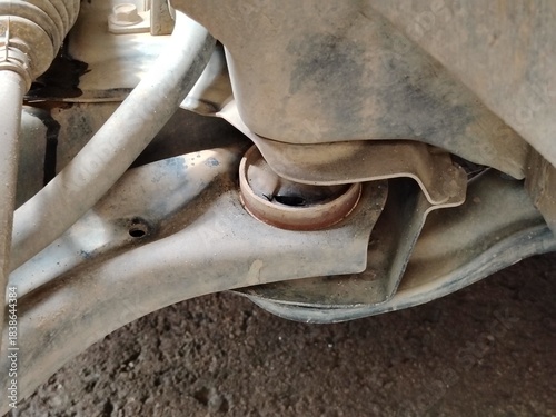 Underneath the Car: Dirty, Worn-Out Components Showing Rust and Rubber Failure.