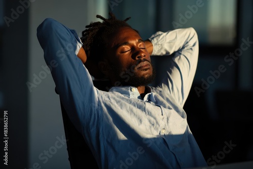 A focused professional takes a much-needed mental break relaxing deeply with closed eyes in sunlight