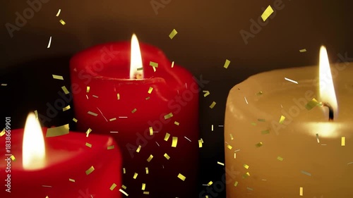 Three pillar candles glowing, gold confetti appearing from above and drifting down for celebration