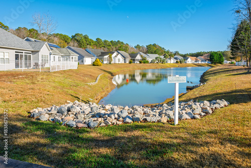 A small pond with a No Swimming sign in a residential community in Little River South Carolina.