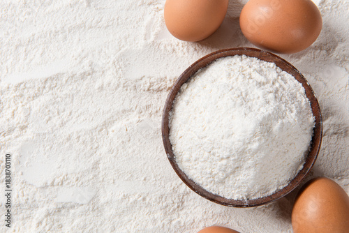 Close-up of white flour with eggs background.