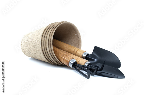 Gardening tools and pots arranged on a white background for planting