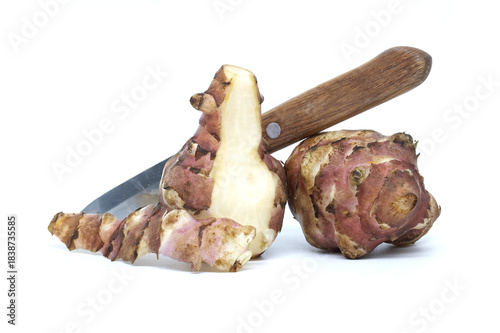 Jerusalem artichokes with a knife isolated on a white background