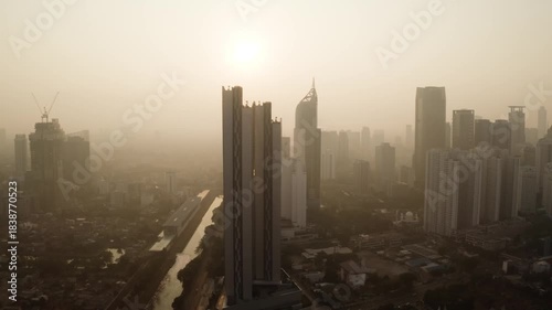 Hazy Sunrise Over Jakarta's Indonesia-1 Twin Towers and Urban Sprawl