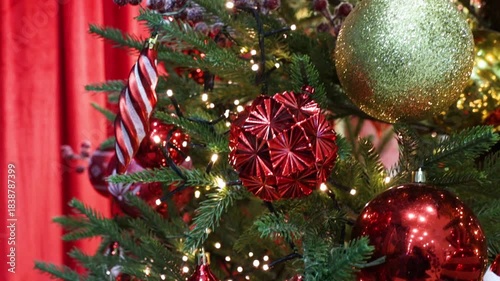 The Christmas tree is decorated with glittering ornaments and sparkling lights.