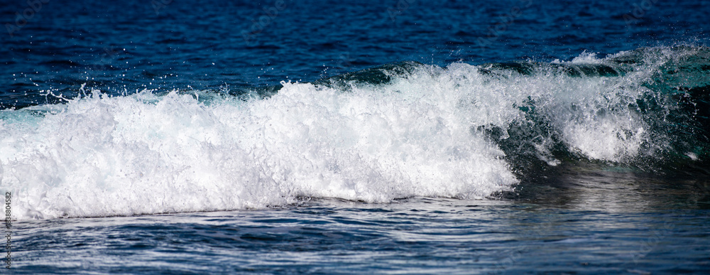 Fototapeta premium Rolling sea waves movement. Wave background. Soft sea waves. Abstract ocean texture. Transparent sea waves with foam sparkle.