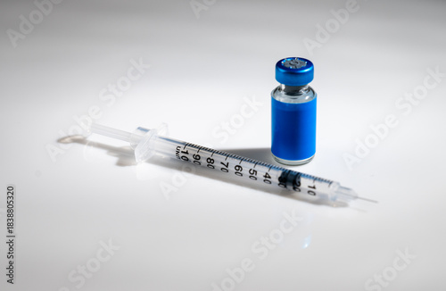 Vászonkép Close up of Glass Vile with Blue Label and Single Use Syringe