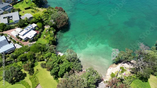Drone aerial move over the turquoise waters of Winstones Cove in New Zealand.