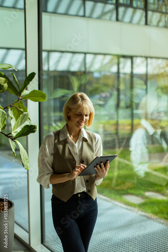 Woman using tablet while st...