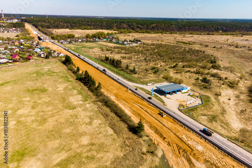 Obraz na plátne Aerial view captures ongoing highway widening project adjacent to a rural settle