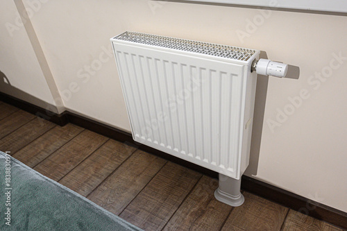 Wallpaper Mural White radiator heater with thermostat control, installed on wooden flooring in a room Torontodigital.ca