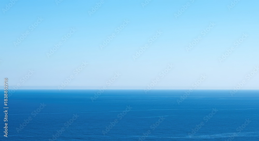 Fototapeta premium Endless blue ocean meeting a distant, slightly hazy horizon under a bright, clear summer sky. A minimalist, tranquil view ,water ,clear ,sunlight