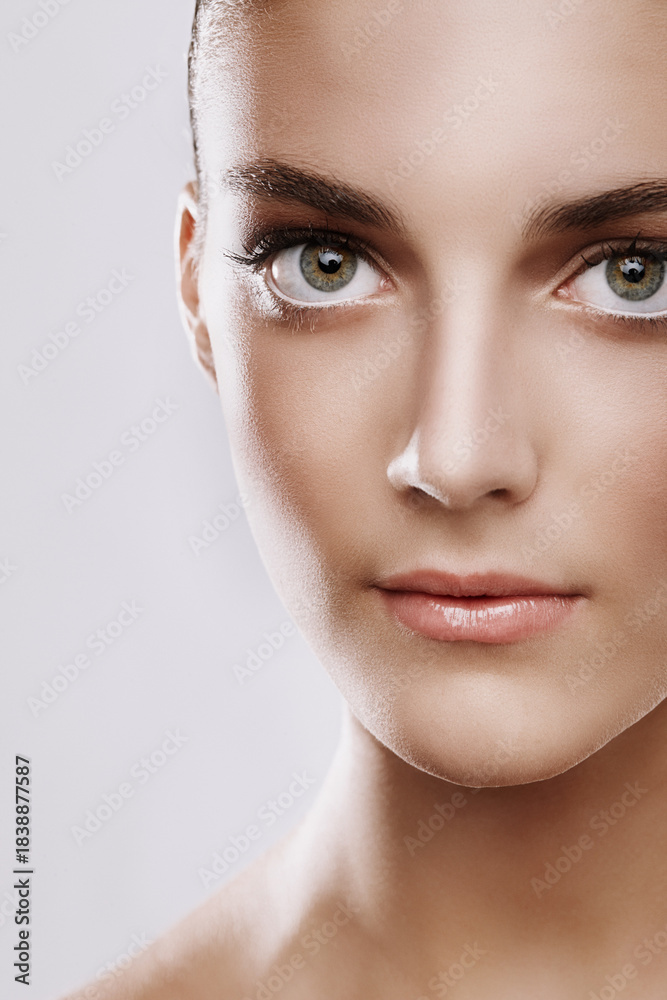Fototapeta premium Portrait, makeup and woman in studio, shine and foundation with confidence on white background. Pride, cosmetics and aesthetic with person, beauty and glow with facial collagen, smooth and wellness