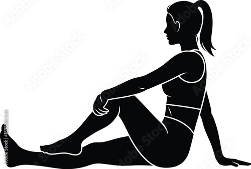 Silhouette of a woman stretching her leg while seated in a yoga pose