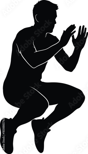 Silhouette of a man performing a knee tuck jump