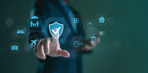 Businessman touching digital screen with insurance icons. Concept of online insurance service, protection plan, financial security, and insurtech innovation for health, travel, and property coverage.