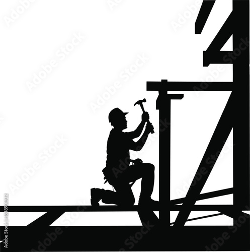 Silhouette of construction worker kneeling and hammering wooden framework on building site representing labor, craftsmanship, effort, structure, and industry