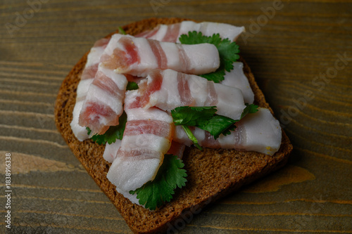 Rustic Black Bread with Salo on Aged Wood Table