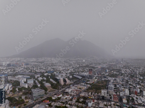 Urban Monterrey skyline with Cerro de la Silla Mountains obscured by heavy smog and pollution