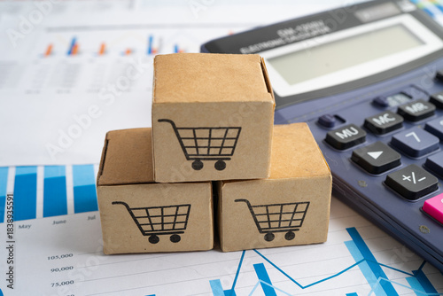 Online shopping, Shopping cart box and calculator on business graph, import export, finance commerce.