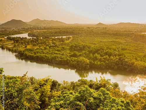 Aerial view of a tropical river valley at sunset.