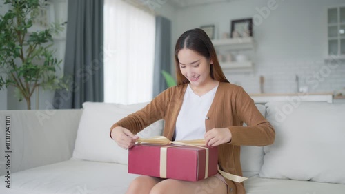 Asian young woman opening a gift box. Happy new year, Thanksgiving
